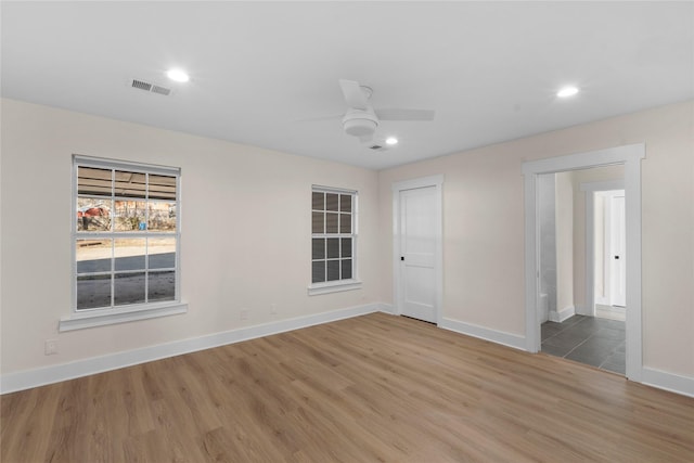 spare room with hardwood / wood-style floors and ceiling fan