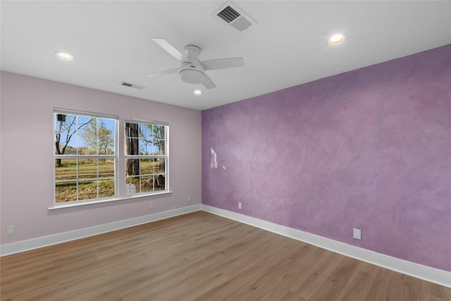 spare room with ceiling fan and wood-type flooring