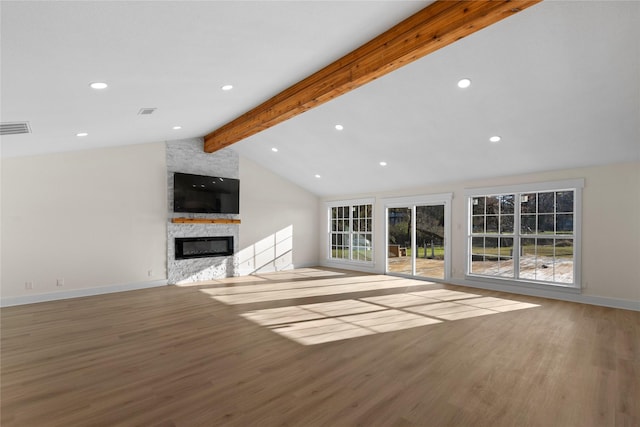 unfurnished living room with hardwood / wood-style flooring, vaulted ceiling with beams, and a fireplace