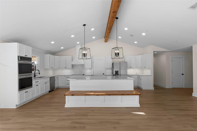 kitchen featuring white cabinets, decorative backsplash, and a kitchen island