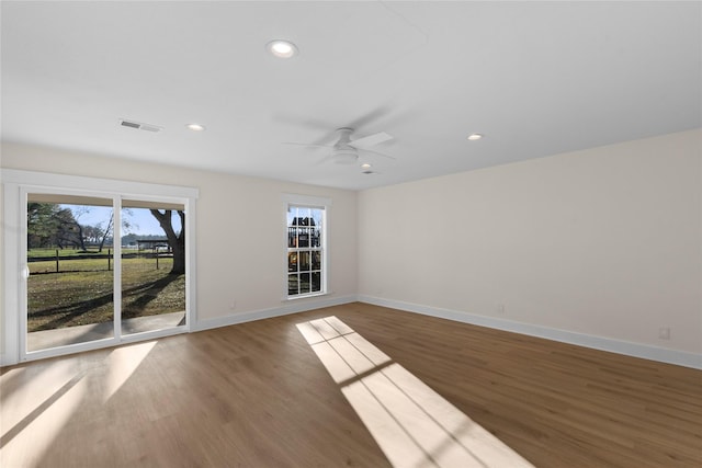 unfurnished room featuring ceiling fan and dark hardwood / wood-style flooring