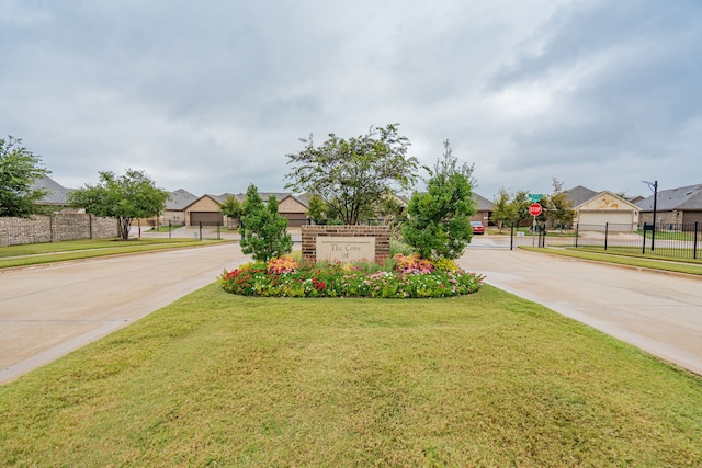 exterior space with a residential view, fence, and a lawn