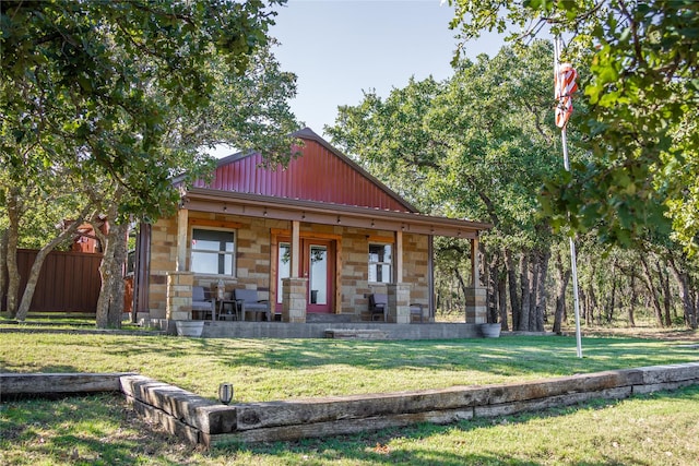 view of front of home with a porch and a front yard