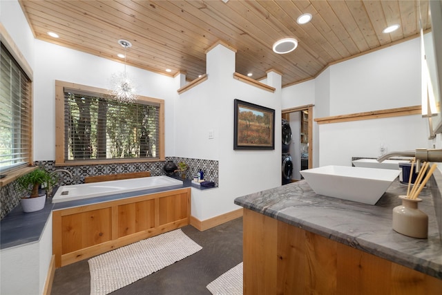 bathroom with vanity, crown molding, stacked washer and clothes dryer, wooden ceiling, and a notable chandelier