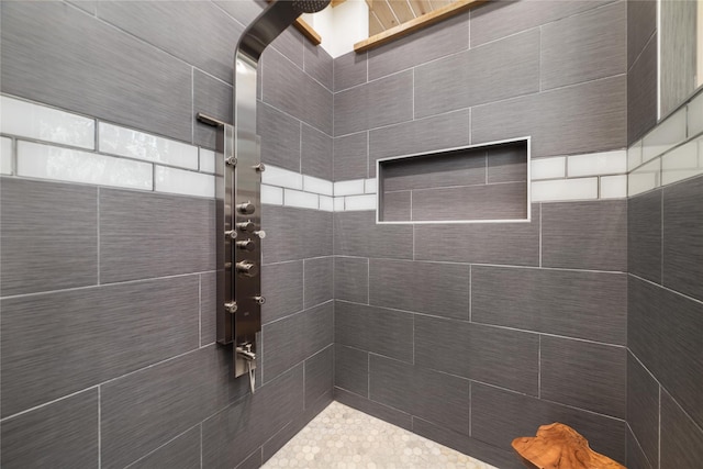 bathroom with tiled shower