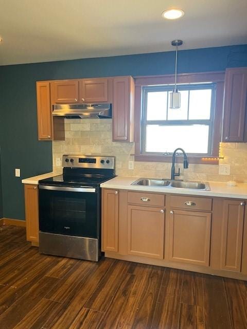 kitchen with backsplash, sink, hanging light fixtures, stainless steel electric range oven, and dark hardwood / wood-style flooring