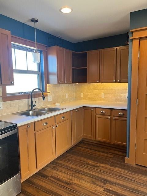 kitchen featuring a sink, light countertops, stainless steel electric stove, open shelves, and decorative light fixtures