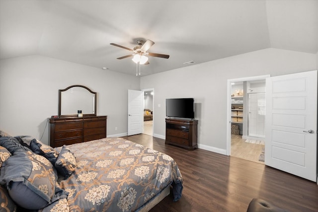 bedroom with ceiling fan, dark hardwood / wood-style flooring, lofted ceiling, and ensuite bathroom