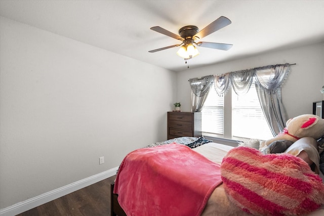 bedroom with dark hardwood / wood-style floors and ceiling fan