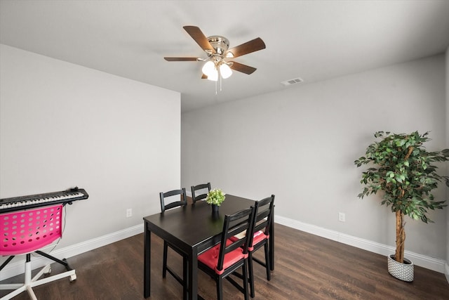 dining space with dark hardwood / wood-style flooring and ceiling fan