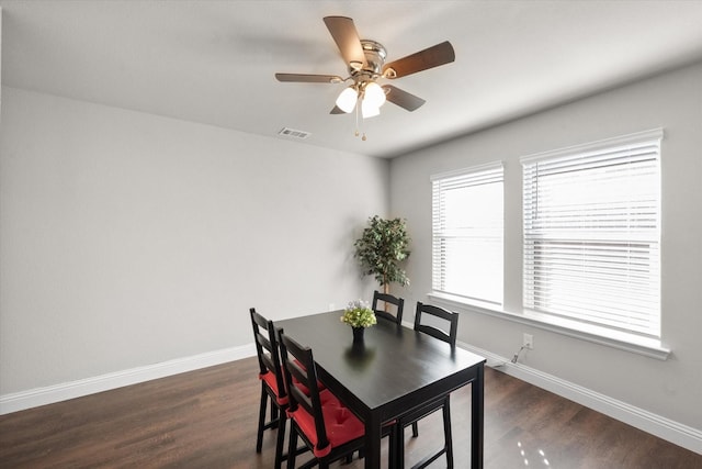 dining area with dark hardwood / wood-style flooring, ceiling fan, and plenty of natural light