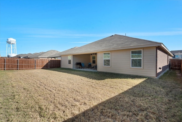 rear view of house with a patio area and a yard