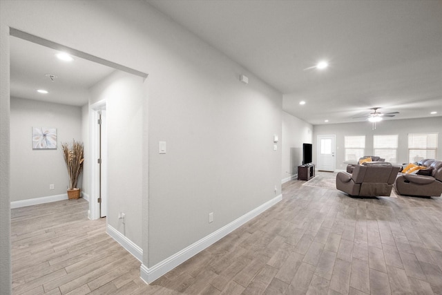 corridor with light hardwood / wood-style floors