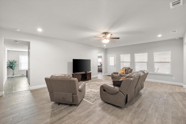 living room featuring ceiling fan and light hardwood / wood-style floors