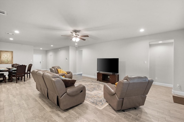 living room featuring light wood-type flooring and ceiling fan