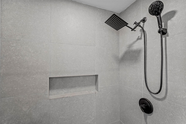 interior details featuring tiled shower