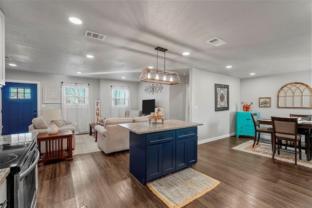 kitchen with stainless steel electric stove, hanging light fixtures, dark hardwood / wood-style flooring, and a kitchen island