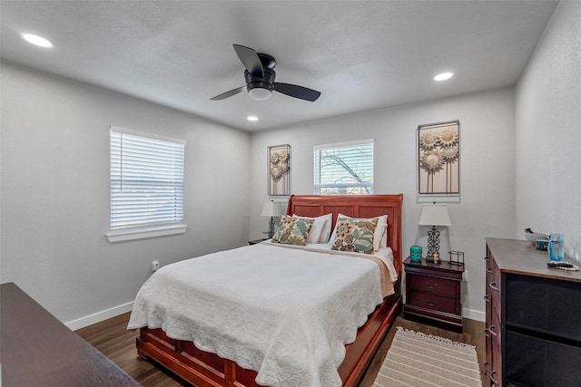 bedroom with ceiling fan and dark wood-type flooring