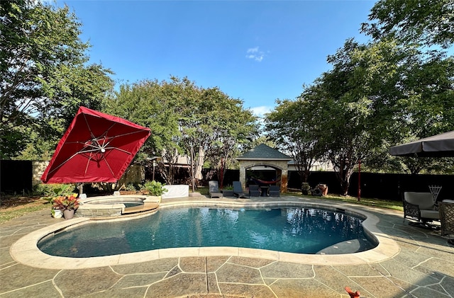 view of pool featuring an in ground hot tub, a gazebo, and a patio