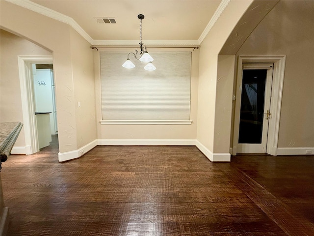 unfurnished dining area featuring dark hardwood / wood-style floors, crown molding, and an inviting chandelier