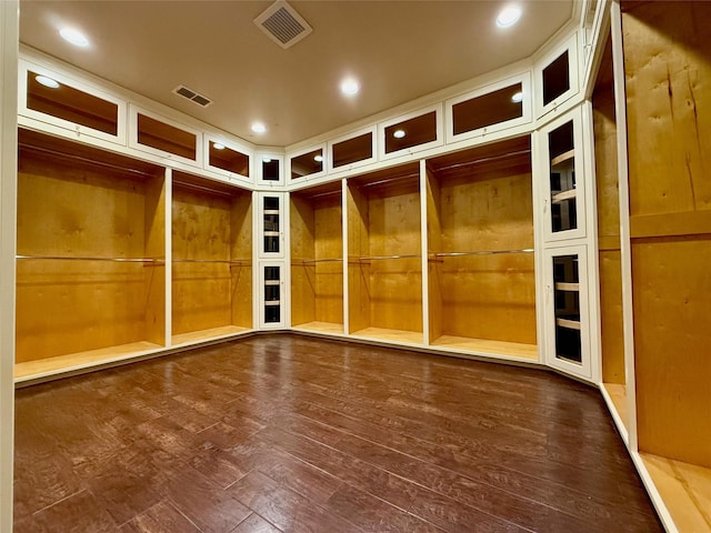 empty room featuring dark hardwood / wood-style flooring and wooden walls