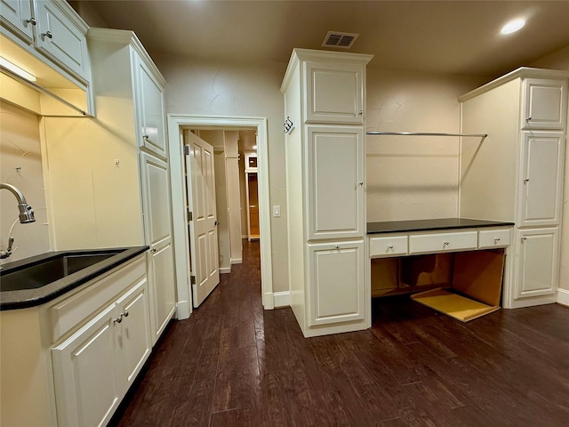 kitchen with white cabinetry, dark hardwood / wood-style floors, and sink