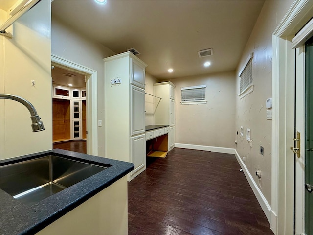 kitchen featuring dark hardwood / wood-style flooring, white cabinets, and sink