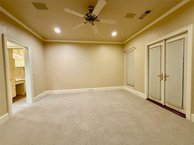 unfurnished bedroom featuring ceiling fan, ornamental molding, a closet, and light colored carpet