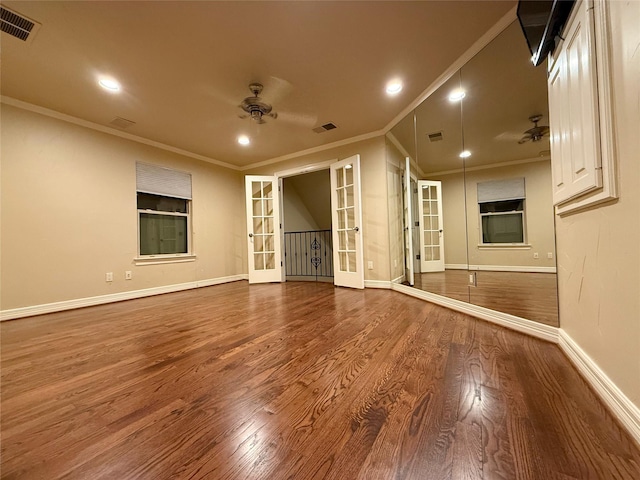 spare room featuring ceiling fan, french doors, ornamental molding, and hardwood / wood-style floors