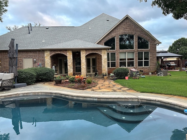 rear view of house featuring a gazebo, french doors, and a yard