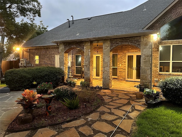 back of property with french doors and a patio