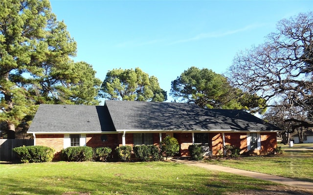 ranch-style home featuring a front yard