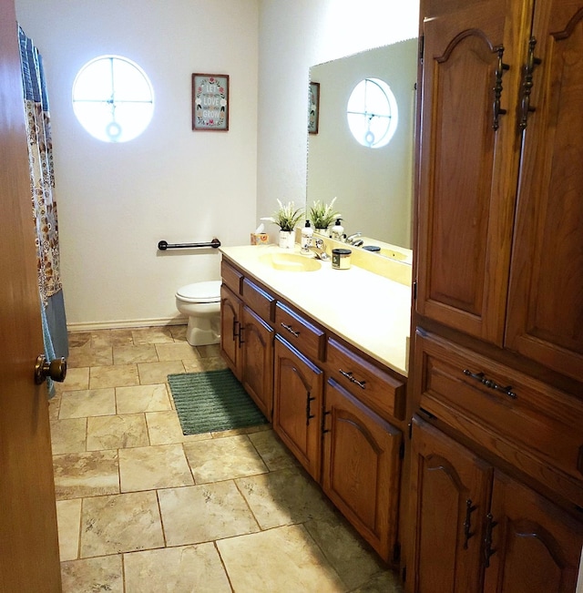 bathroom with toilet and vanity