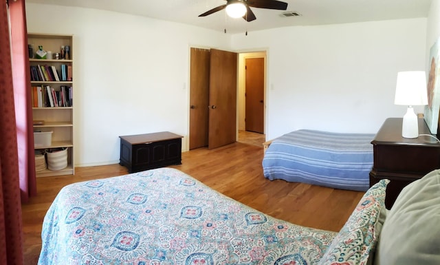 bedroom with hardwood / wood-style floors and ceiling fan