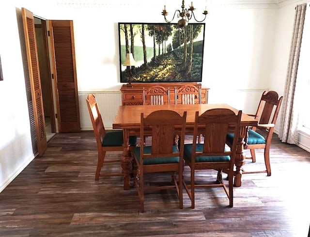 dining area featuring dark hardwood / wood-style floors and a notable chandelier