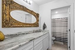 bathroom featuring vanity and toilet