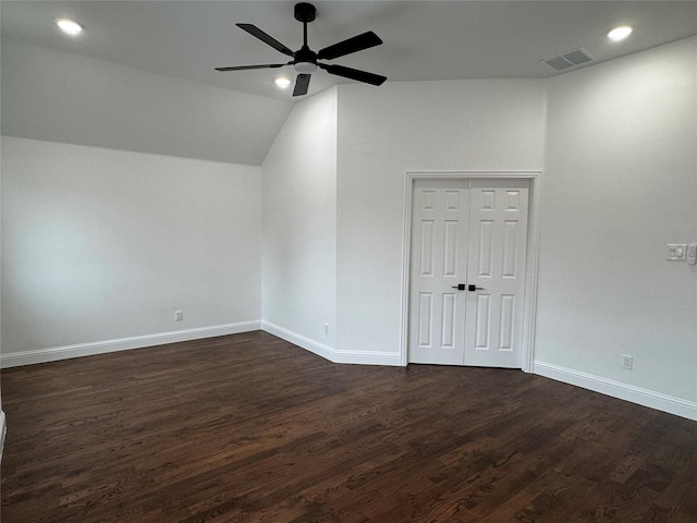 spare room with vaulted ceiling, dark hardwood / wood-style floors, and ceiling fan