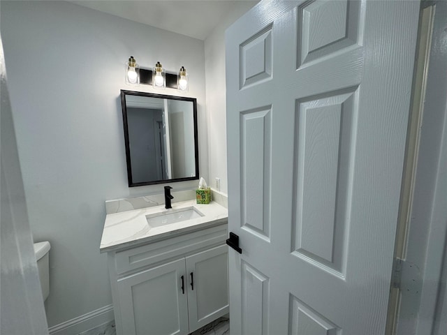 bathroom featuring vanity and toilet