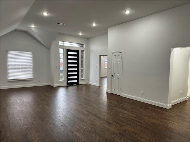 foyer entrance featuring lofted ceiling and dark hardwood / wood-style floors