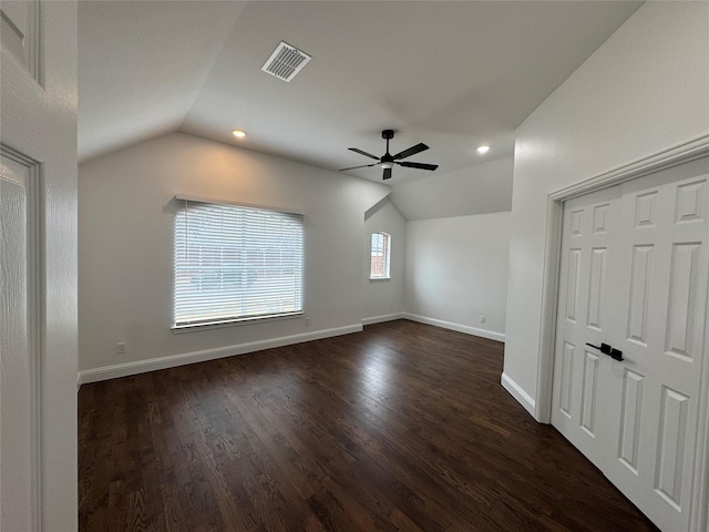 additional living space featuring plenty of natural light, dark hardwood / wood-style floors, and vaulted ceiling