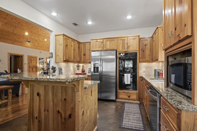 kitchen featuring a breakfast bar, wooden ceiling, backsplash, dark stone countertops, and stainless steel appliances