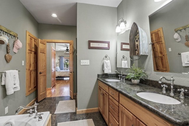 bathroom with vanity and a tub