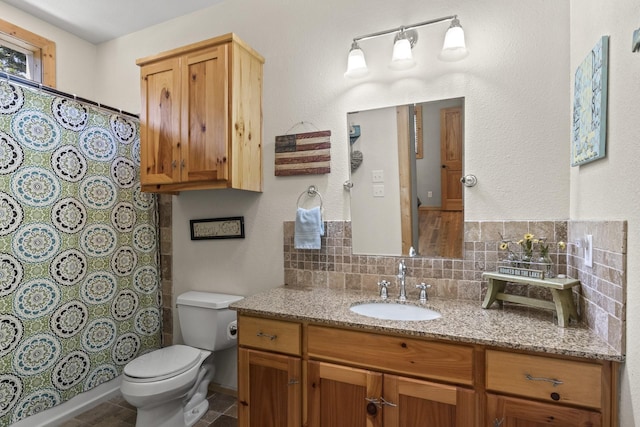 bathroom featuring curtained shower, decorative backsplash, vanity, and toilet