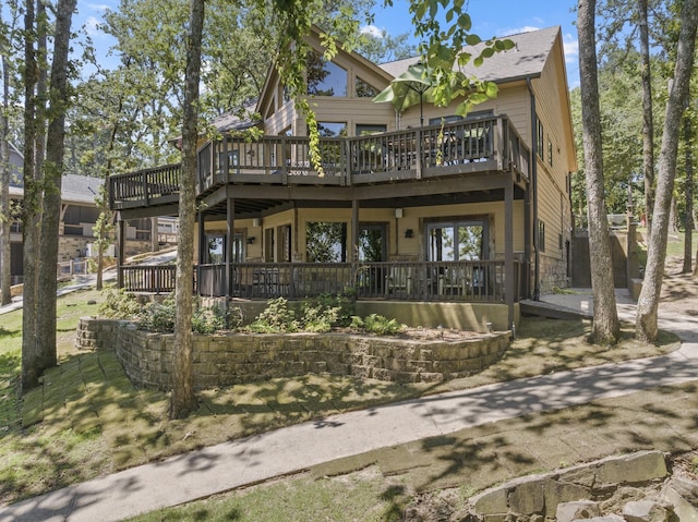 rear view of property with a wooden deck