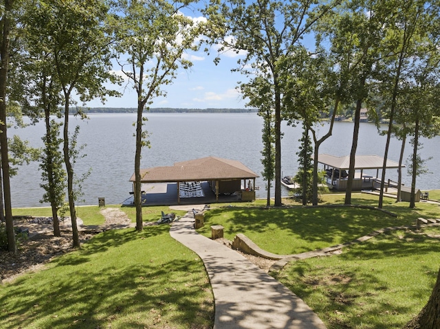 surrounding community with a gazebo, a yard, and a water view