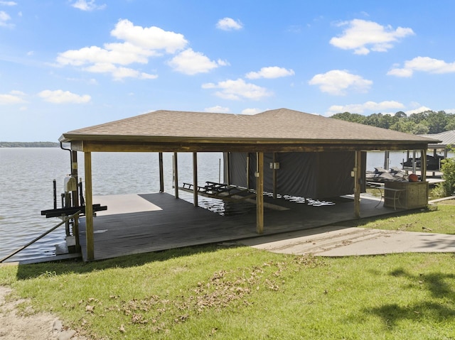 view of dock featuring a water view and a lawn