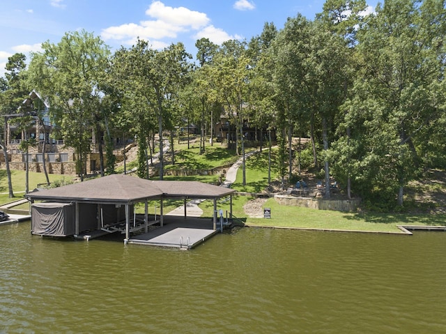 dock area featuring a lawn and a water view