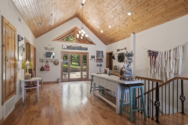 interior space featuring a chandelier, hardwood / wood-style floors, high vaulted ceiling, and wood ceiling