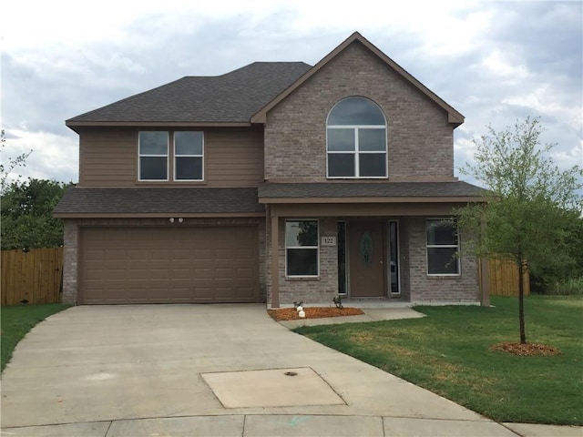 view of front of property with a garage and a front yard