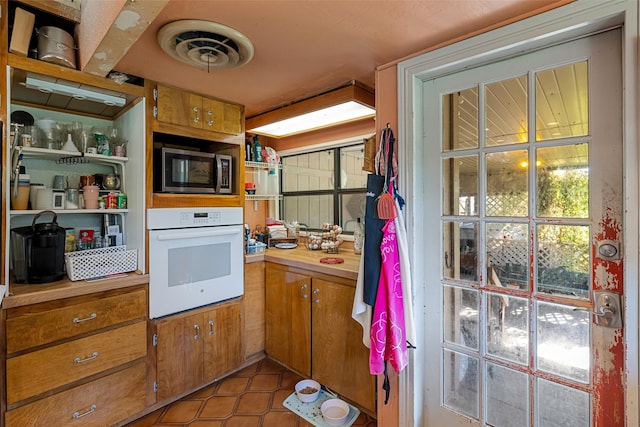 kitchen featuring light tile patterned flooring and white oven